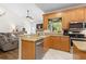 Kitchen with breakfast bar and views to the living room at 7737 40Th E Ct, Sarasota, FL 34243