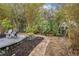 Curving brick path meanders through lush landscaping at 7737 40Th E Ct, Sarasota, FL 34243