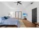 Main bedroom with wood floors and private access to the backyard at 7737 40Th E Ct, Sarasota, FL 34243