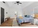 Main bedroom with vaulted ceilings, wood floors and en-suite bathroom at 7737 40Th E Ct, Sarasota, FL 34243