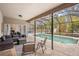 Relaxing poolside patio with comfortable seating and a screened enclosure at 7737 40Th E Ct, Sarasota, FL 34243