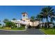 Luxury clubhouse entrance with palm trees and landscaping at 8115 Miramar Way # 202, Lakewood Ranch, FL 34202
