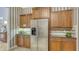 Community kitchen with refrigerator and wood cabinets at 8115 Miramar Way # 202, Lakewood Ranch, FL 34202