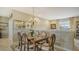 Formal dining room with wooden table, six chairs, and a crystal chandelier at 8115 Miramar Way # 202, Lakewood Ranch, FL 34202