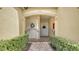 Front entry with wrought iron gates and brick walkway, leading to a double door entry at 8115 Miramar Way # 202, Lakewood Ranch, FL 34202