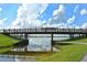 Wooden footbridge over calm water with reflections and lush green banks at 8115 Miramar Way # 202, Lakewood Ranch, FL 34202
