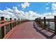 Modern wooden footbridge with railings, offering a scenic lakeside view at 8115 Miramar Way # 202, Lakewood Ranch, FL 34202
