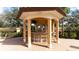 Covered outdoor bar and seating area with a TV at 8115 Miramar Way # 202, Lakewood Ranch, FL 34202