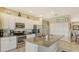 Island kitchen with granite countertops and stainless steel appliances at 8115 Miramar Way # 202, Lakewood Ranch, FL 34202