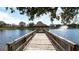 Wooden pier and gazebo overlooking a tranquil lake at 8115 Miramar Way # 202, Lakewood Ranch, FL 34202