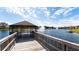 Wooden pier leads to gazebo on calm lake with fountain at 8115 Miramar Way # 202, Lakewood Ranch, FL 34202