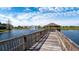 Wooden walkway to gazebo over serene lake at 8115 Miramar Way # 202, Lakewood Ranch, FL 34202