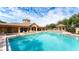 Resort-style pool with clubhouse, spa, and lounge chairs at 8115 Miramar Way # 202, Lakewood Ranch, FL 34202