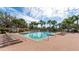 Relaxing pool area with lounge chairs and palm trees at 8115 Miramar Way # 202, Lakewood Ranch, FL 34202