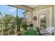 Peaceful screened balcony with seating and abundant potted plants at 8115 Miramar Way # 202, Lakewood Ranch, FL 34202