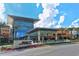 Modern shopping mall exterior with palm trees and clear blue sky at 8115 Miramar Way # 202, Lakewood Ranch, FL 34202