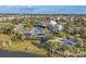 An aerial of the community pool area with modern architecture, palm trees, and beautiful landscaping at 9230 Isabella Cir, Parrish, FL 34219