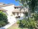Cute condo with landscaped front yard, white gate, and walkway at 4615 Hidden View Pl # 26, Sarasota, FL 34235