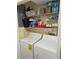 Laundry closet with washer, dryer, and storage shelves at 4615 Hidden View Pl # 26, Sarasota, FL 34235
