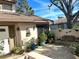 Private patio with brick pavers, potted plants, and a bench at 4615 Hidden View Pl # 26, Sarasota, FL 34235