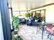 Spacious covered patio with wicker furniture and plants at 4615 Hidden View Pl # 26, Sarasota, FL 34235