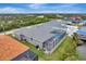 Aerial view showcasing a home's pool and screened enclosure at 10442 Winnipeg St, Port Charlotte, FL 33981