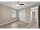 Charming bedroom with wood-look floors and ceiling fan at 10442 Winnipeg St, Port Charlotte, FL 33981
