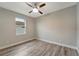 Simple bedroom with wood-look floors and ceiling fan at 10442 Winnipeg St, Port Charlotte, FL 33981