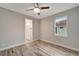 Bright bedroom featuring wood-look floors and ceiling fan at 10442 Winnipeg St, Port Charlotte, FL 33981