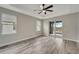 Spacious bedroom with wood-look floors and sliding glass doors to a patio at 10442 Winnipeg St, Port Charlotte, FL 33981