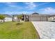 Gray house with three-car garage and paver driveway at 10442 Winnipeg St, Port Charlotte, FL 33981