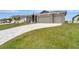 House exterior showcasing a paver driveway and landscaping at 10442 Winnipeg St, Port Charlotte, FL 33981