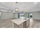 Open kitchen features a large island, stainless steel appliances, and views of the pool at 10442 Winnipeg St, Port Charlotte, FL 33981