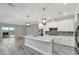 Modern kitchen with white cabinets, large island, and stainless steel appliances at 10442 Winnipeg St, Port Charlotte, FL 33981