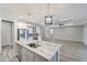 Modern kitchen with white cabinets, large island with marble countertop and stainless steel appliances at 10442 Winnipeg St, Port Charlotte, FL 33981