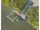 Aerial view of a dock with a kayak lift at 114 Gull Dr, Anna Maria, FL 34216