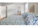 Bedroom with light blue bedding and access to bathroom at 114 Gull Dr, Anna Maria, FL 34216