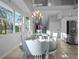Spacious dining room with large table and chandelier at 114 Gull Dr, Anna Maria, FL 34216