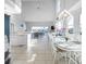 Open kitchen and dining area with large table and water views at 114 Gull Dr, Anna Maria, FL 34216