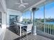 Outdoor patio with dining area and water views at 114 Gull Dr, Anna Maria, FL 34216