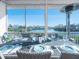 Screened patio with water views, dining table, and heater at 114 Gull Dr, Anna Maria, FL 34216