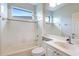 Small bathroom with white tile and shower/tub combo at 11662 Old Cypress Cv, Parrish, FL 34219