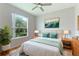 Bedroom with hardwood floors, window, and ceiling fan at 11662 Old Cypress Cv, Parrish, FL 34219