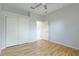Bedroom with hardwood floors, double closet, and ceiling fan at 11662 Old Cypress Cv, Parrish, FL 34219