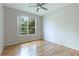 Light-filled bedroom with hardwood floors and large window at 11662 Old Cypress Cv, Parrish, FL 34219