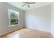 Bright bedroom with hardwood floors and large window at 11662 Old Cypress Cv, Parrish, FL 34219