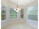 Bright breakfast nook with three windows and tile floors at 11662 Old Cypress Cv, Parrish, FL 34219