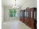 Bright dining room featuring tile floors and large window at 11662 Old Cypress Cv, Parrish, FL 34219