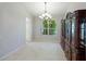 Bright dining room with tile floors and access to kitchen at 11662 Old Cypress Cv, Parrish, FL 34219