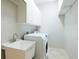 Laundry room with washer, dryer, sink, and cabinets at 11662 Old Cypress Cv, Parrish, FL 34219